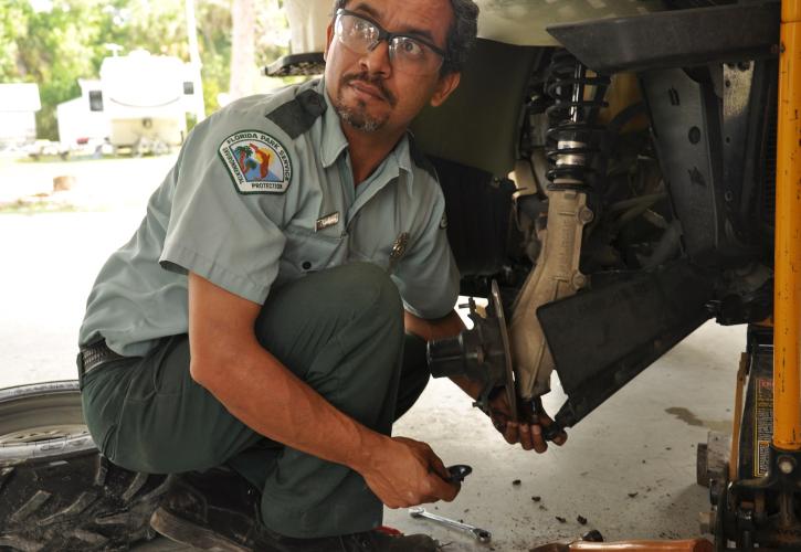 Man repairing an ATV brake