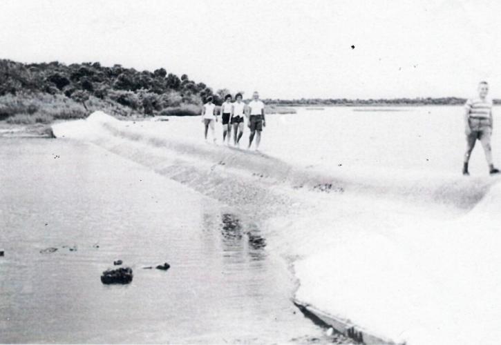 Visitors walk along the Weir