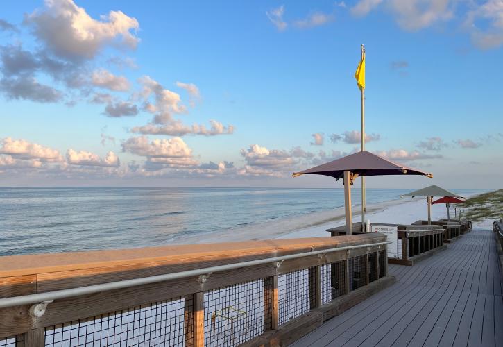 Covered rest areas along the boardwalk to the beach.