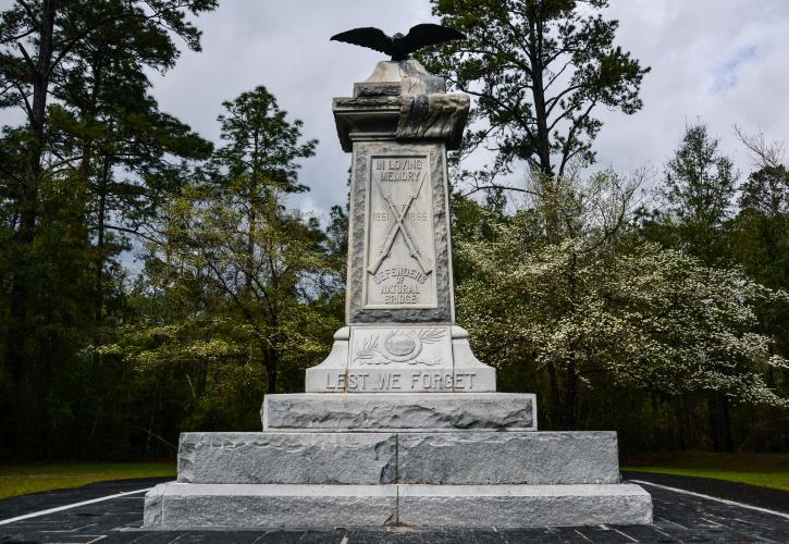 Natural Bridge Monument with dogwoods blooming in background. 