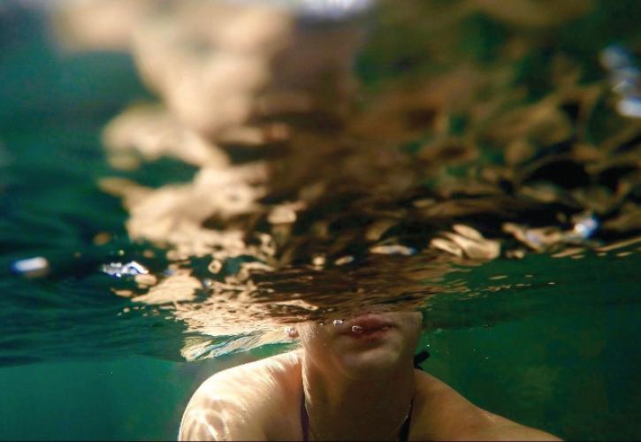 a person swims just below the surface of the water