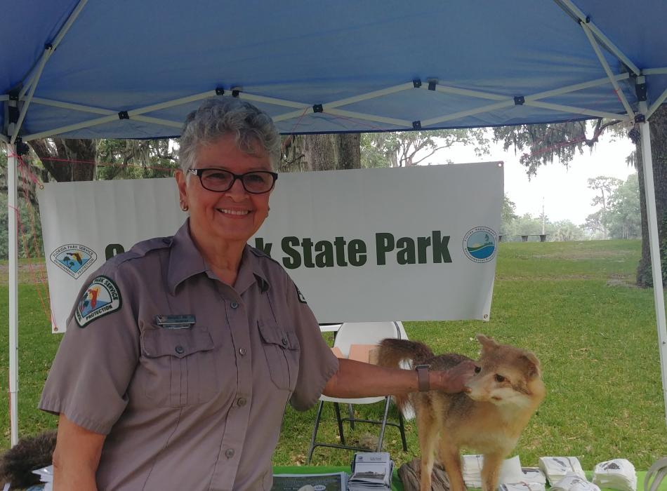 Volunteer Margaret Von Ehr smiling at the camera at an outreach event