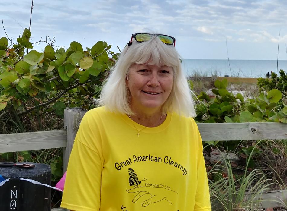Karen Blackford standing in front of the beach