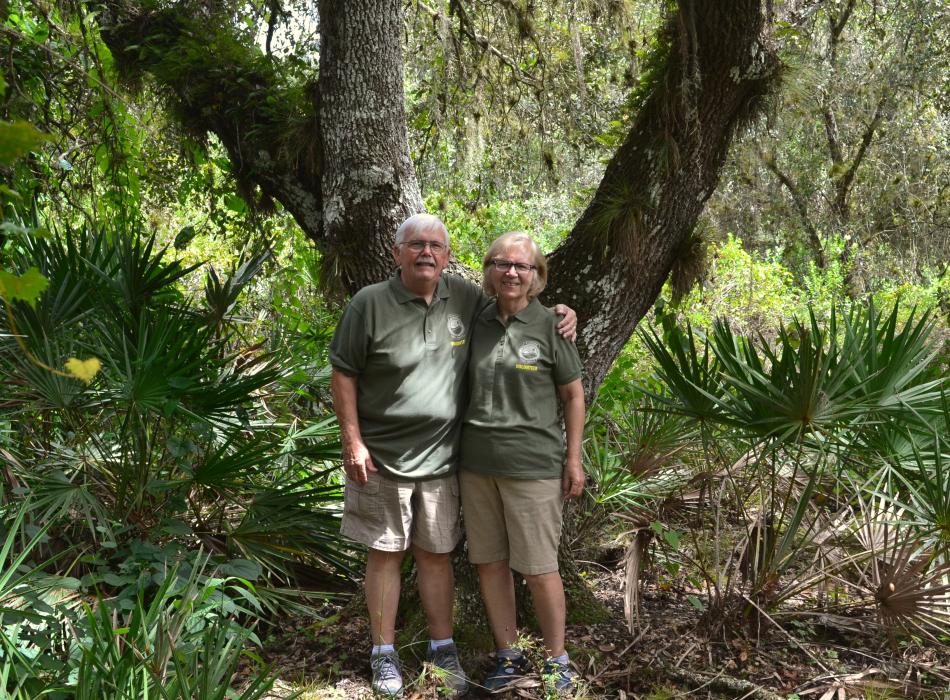 volunteers Barry and Rosalie Coddington standing in front of a beautiful live oak