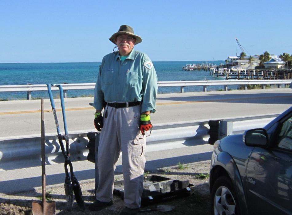 Park Ranger David Hughes working to remove a sign post