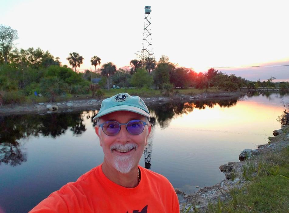 Dino Barone taking a selfie in front of a lake.