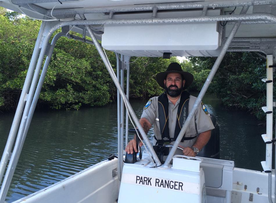 Park Ranger Elizer Pino is on a boat in a mangrove Channel