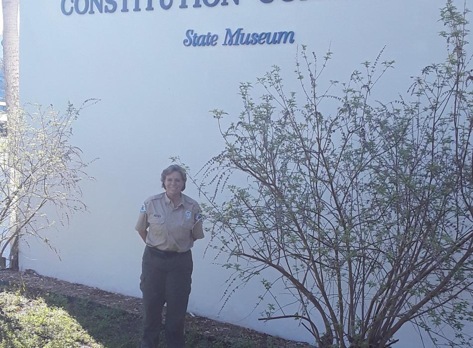 Park Ranger Joanna Lindsey stands proudly in front of the Constitution Convention Museum. 