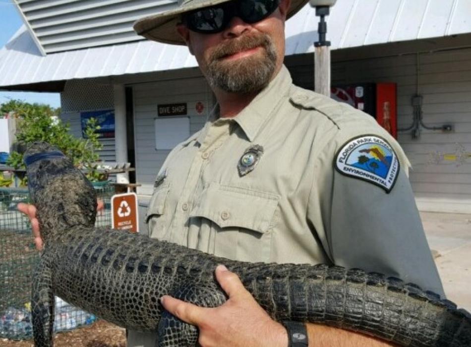 Shep holding a small alligator.